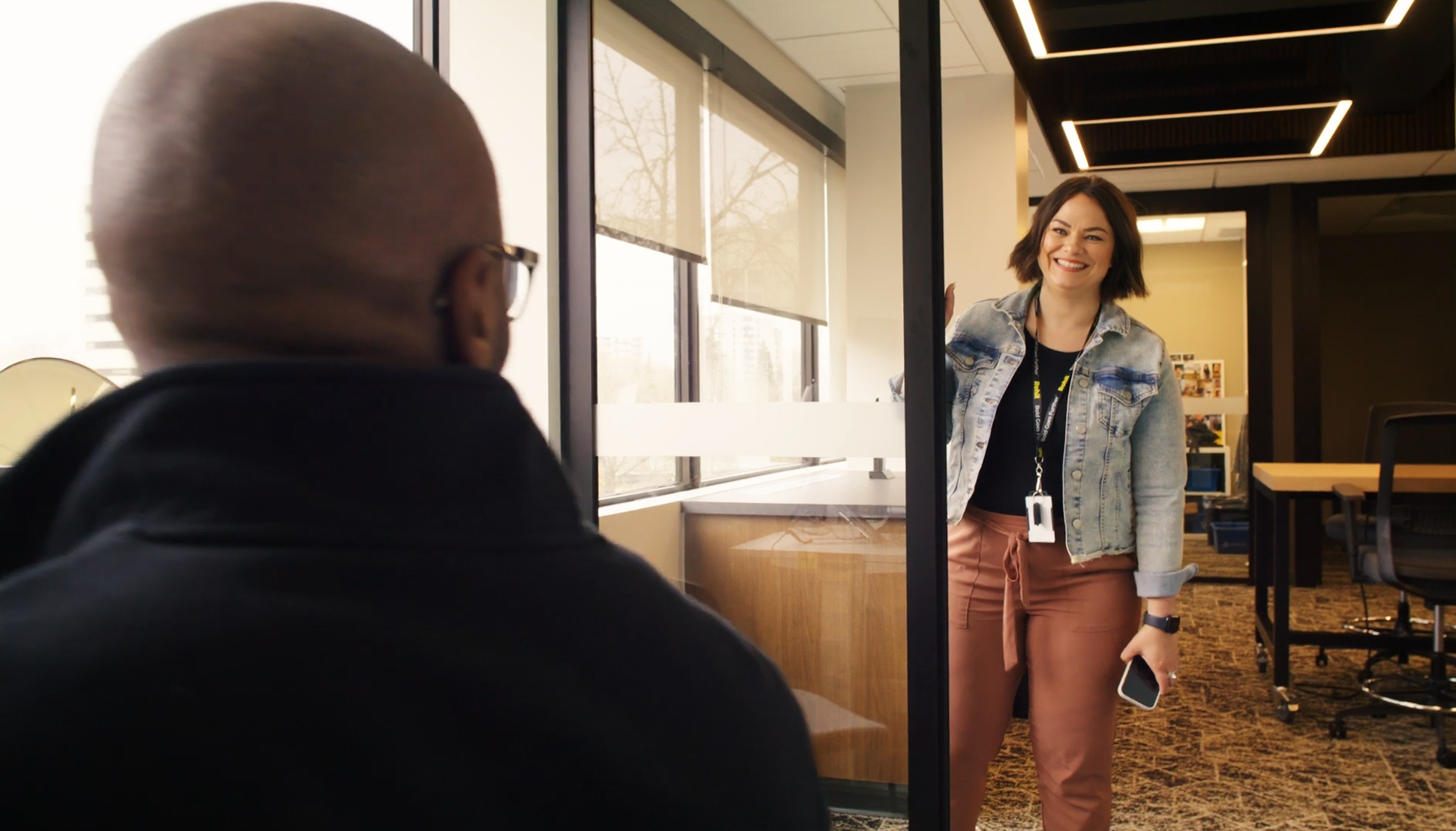 Woman walking into room to talk to a manager.